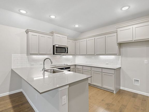 Kitchen in the Pulitzer home plan by Trophy Signature Homes - REPRESENTATIVE PHOTO