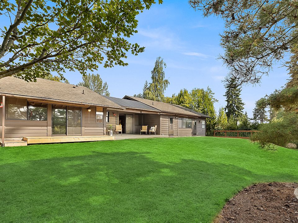 This is a view of the backyard showing a large lawn (it is now seasonally brown). The backyard is fenced.