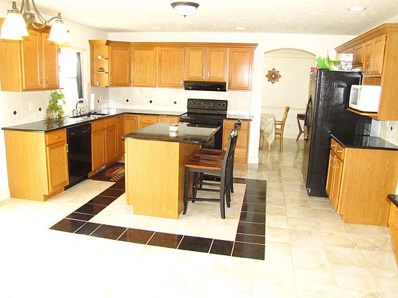 Eat in kitchen with breakfast bar, pantry closet and table area.