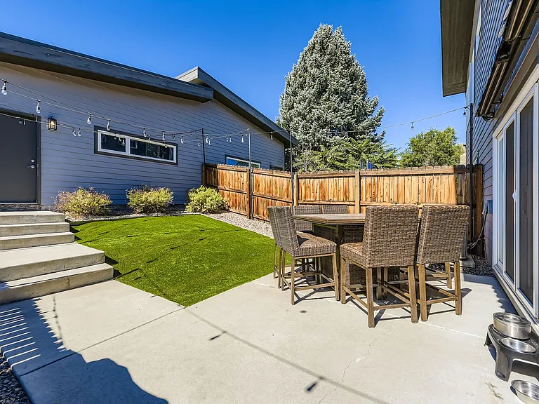 Enclosed backyard with artificial turf