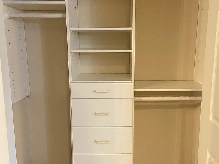 Large closet with built in drawers and shelves