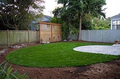 View of tranquil new backyard w/privacy trellis.