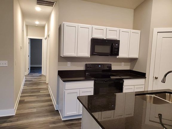 The hallway leads to the bedrooms, bathrooms, and laundry room.