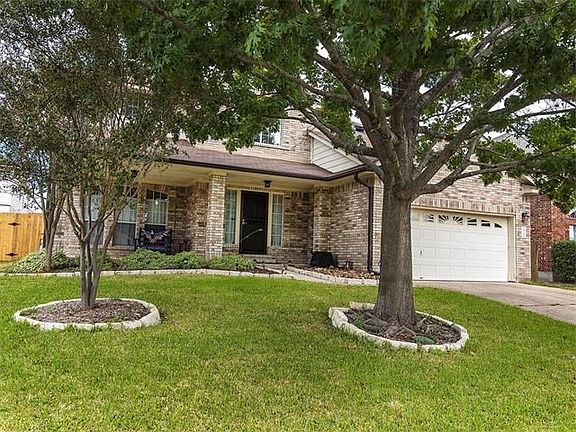 Front of home, beautiful brick. Nice sized trees!