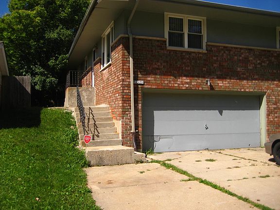 Stairs to front door and shared garage
