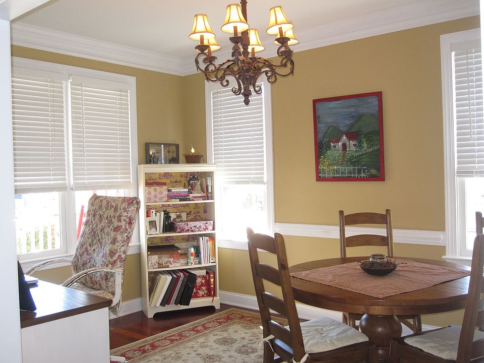 Relax in the sun drenched formal dining room with crown molding and gorgeous c