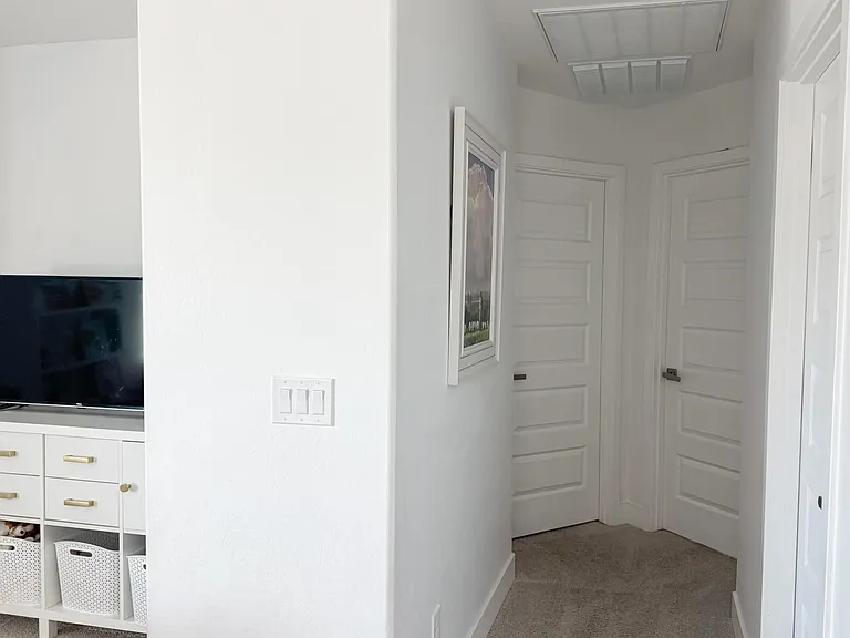 Upstairs hallway, facing Bedroom 2 and Bedroom 3, with Bathroom to the right and Loft to the left