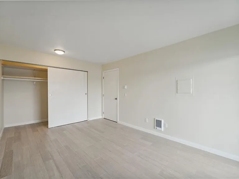 bedroom w/ wood floors & view