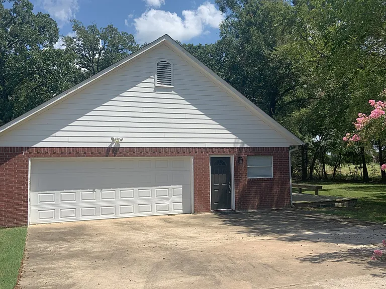 Garage is off a large shared driveway.