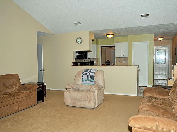 Open interior: family/ living room to kitchen with dry bar
