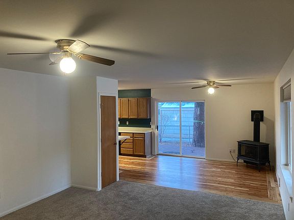 Front room with large picture window and gas fireplace. Small coat closet on left.