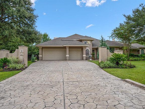 Unlike most homes, the 3 car attached garage is located on the left side of the home, as seen here. A secluded exterior door is just to the right of the driveway making it convenient when bringing in bags of groceries from outside!
