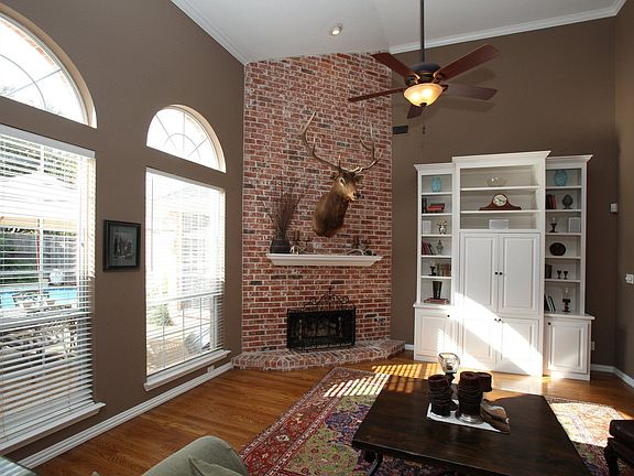 Family room includes a custom built entertainment center, upgraded ceiling fan