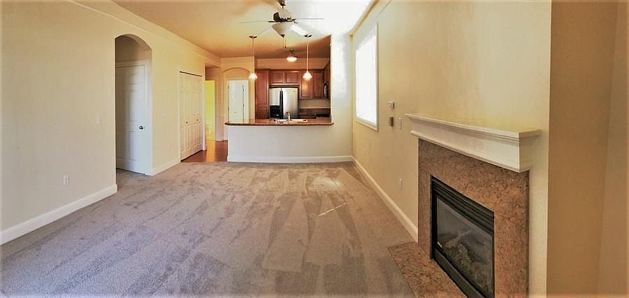 Open living room, high ceilings, gas fireplace