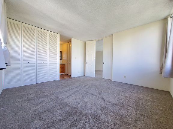Spacious primary bedroom with grand double doors and en suite bathroom