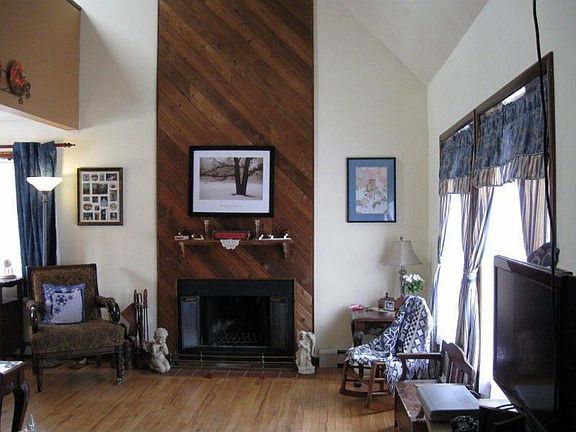 LIVING ROOM WITH HARDWOODS AND VAULTED CEILING