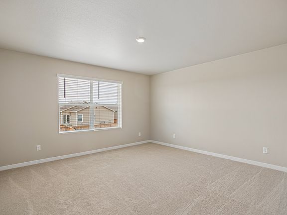 The master bedroom is spacious with a large window.