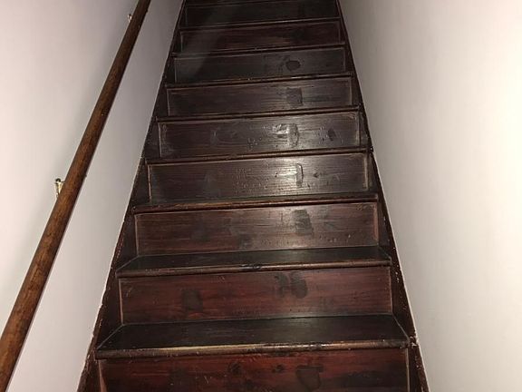 Stairs to the left of the main door.