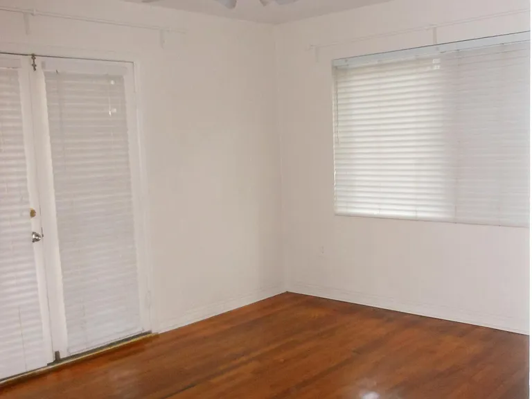 Bedroom and French doors leading to the deck and courtyard
