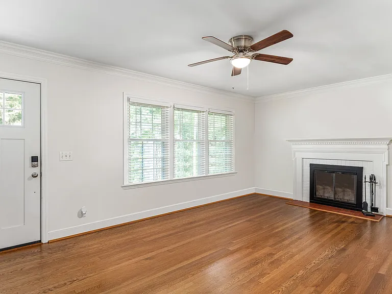 Large living room with wood burning fireplace.