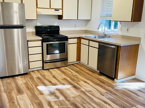 Kitchen with stainless steel appliances and slider to deck.
