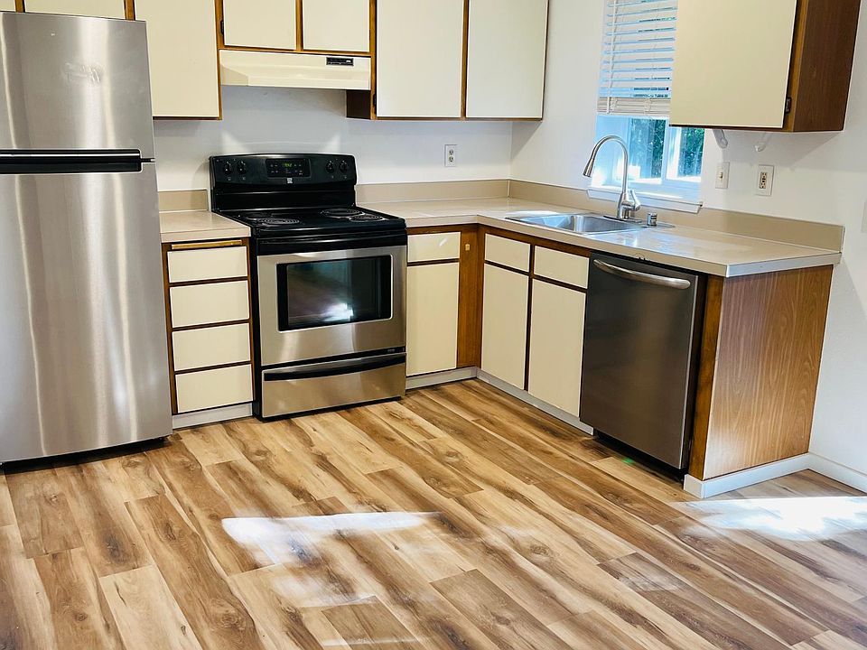 Kitchen with stainless steel appliances and slider to deck.