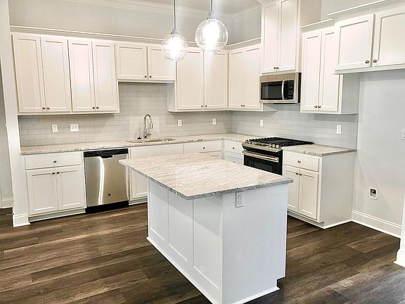 BEAUTIFUL Kitchen with tall white cabinets, upgraded counter tops, fully extending drawers, upgraded undermount rectangular kitchen sink, high end food dispenser (quiet), upgraded back splash and floors.