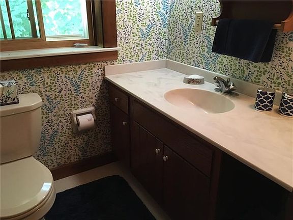 The main bath offers this large vanity with a corian countertop.