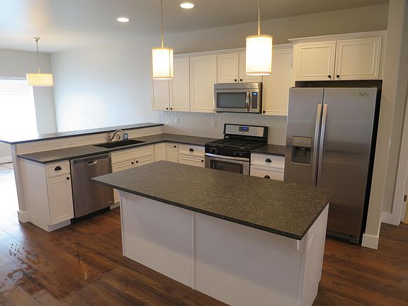 Kitchen with granite counter-tops, stainless steel appliances, gas range