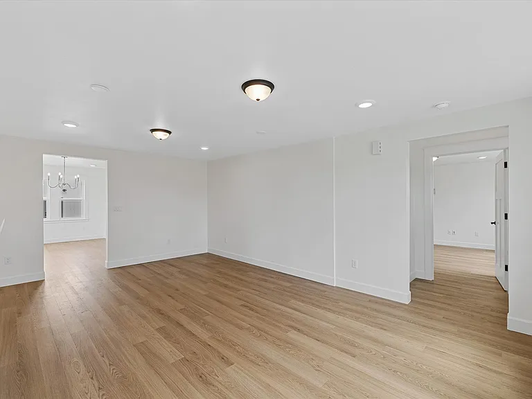 View from formal living to the front entry and through to the versatile family room or second primary suite - however you choose to use it!