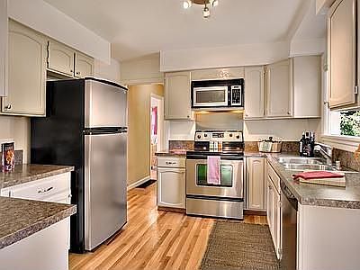 Tastefully updated kitchen opens out to the backyard patio.
