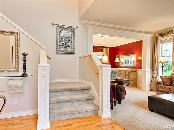 Welcome home! The hardwood floors & gorgeous custom millwork great you as you enter the door.