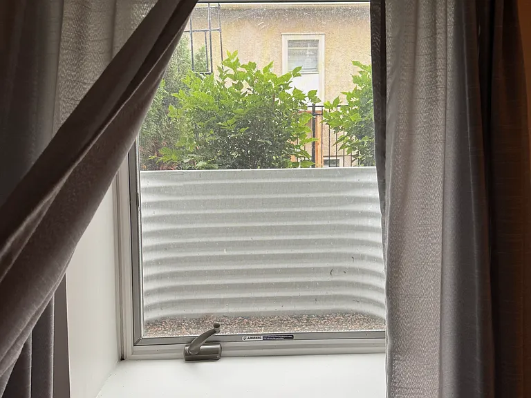 back of house bedroom egress window view