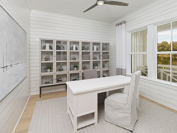 A beautiful home office featuring white shiplap accent walls.
