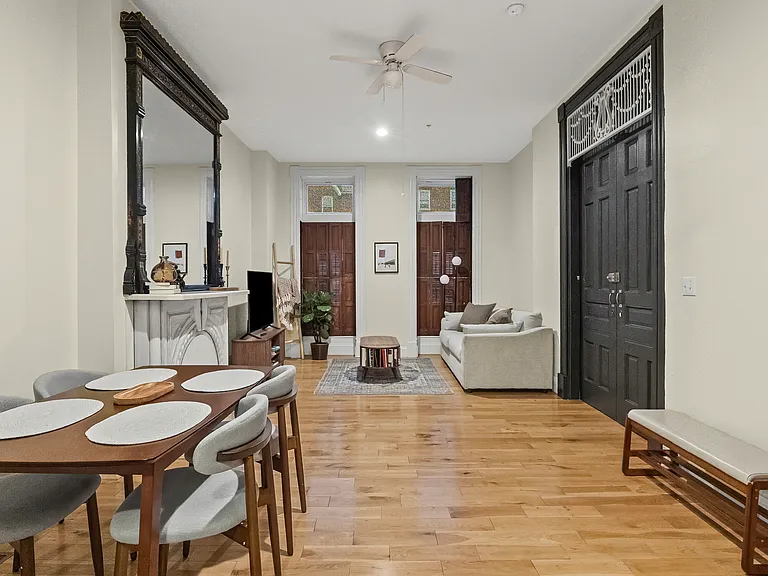 View of grand apartment entrance, and expansive dining and living room.