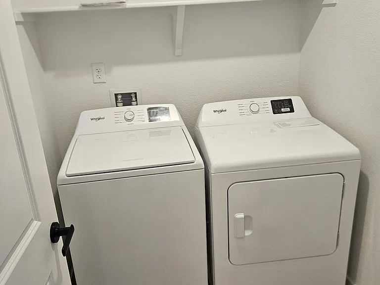 Brand new washer and dryer at the top of the stairs