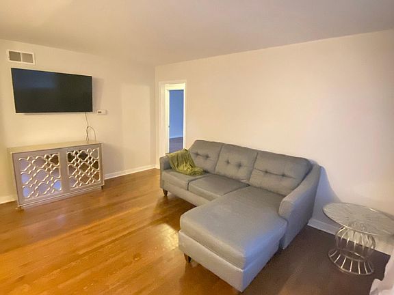 Living Room, comes with tv, entertainment center, sheers, side table and couch.