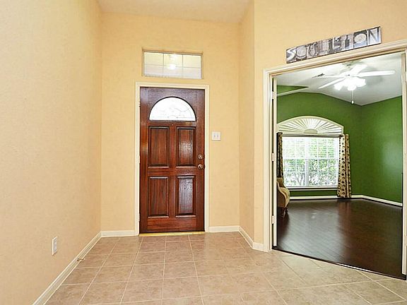 ENTRWAY BOASTS RAISED CEILING, UPGRADED FRONT DOOR, & UPGRADED TILE.  NOTICE HOW THE ENTRY WIDENS AS YOU WALK IN GIVING THIS HOME A SPACIOUS FEEL AS SOON AS YOU SET FOOT IN THE FRONT DOOR.