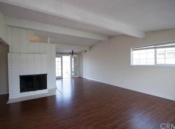 Large and bright living and dining area with a contemporary styled fireplace