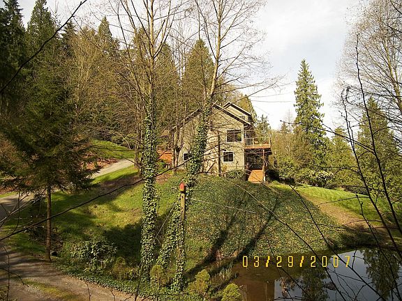View of side of home and Coy Pond