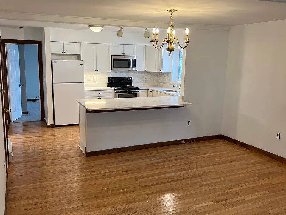 Hardwood floors throughout living area; your view walking in.