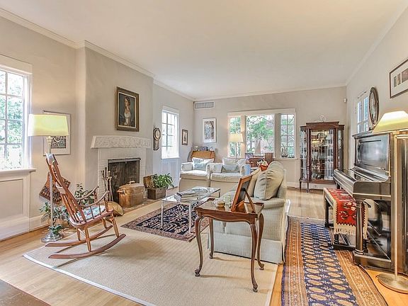 The elegant Living Room surrounds a fireplace while stunning French Doors allow easy access to the sun room.