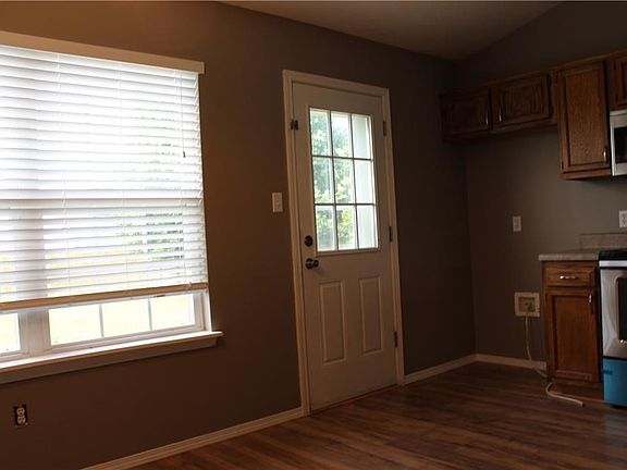 In kitchen, leading out to covered patio and fenced backyard.