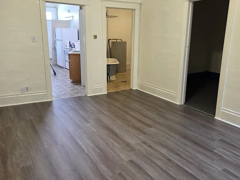 large living room looking towards kitchen. Room is 17ft x 12.5 ft. New laminate flooring