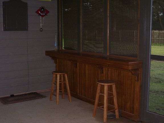 custom built screen porch with surrounding bar