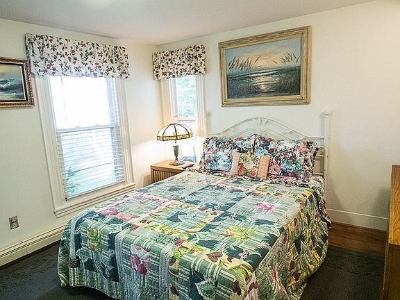 Bedroom with carpeted floor, closet, 2 dressers and televisi