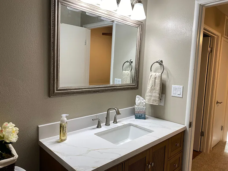 Upstairs bathroom completely redone, new luxury vinyl plank flooring and brand new tub, faucet, dispensers and tub surround, lovely mirrored walls accentuate the new hi-boy elongated toilet, and new griege vanity with engineered marble top with new sink a