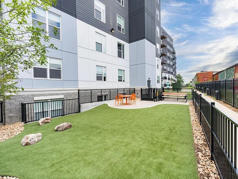 Expansive dog park with open play space and seating, perfect for your four-legged friends.
