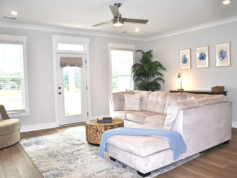 2nd Floor living room with balcony that includes prime lot view of the pond & walking path.