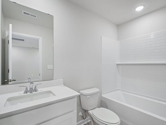A secondary bathroom is adjacent to the secondary bedrooms.